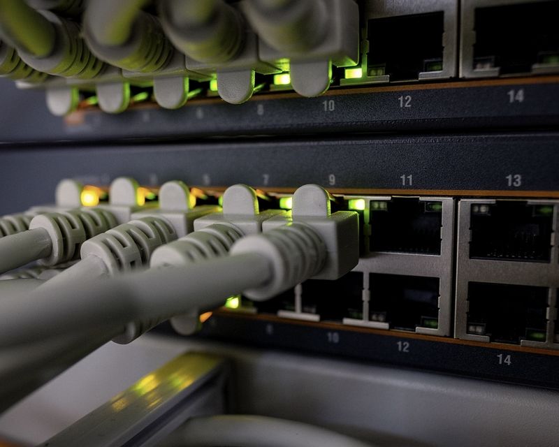 Neatly patched network switch with grey cables in an equipment rack